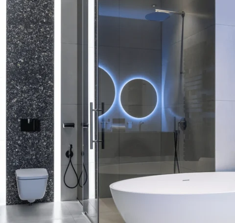 a bathroom with a glass shower door and a tub